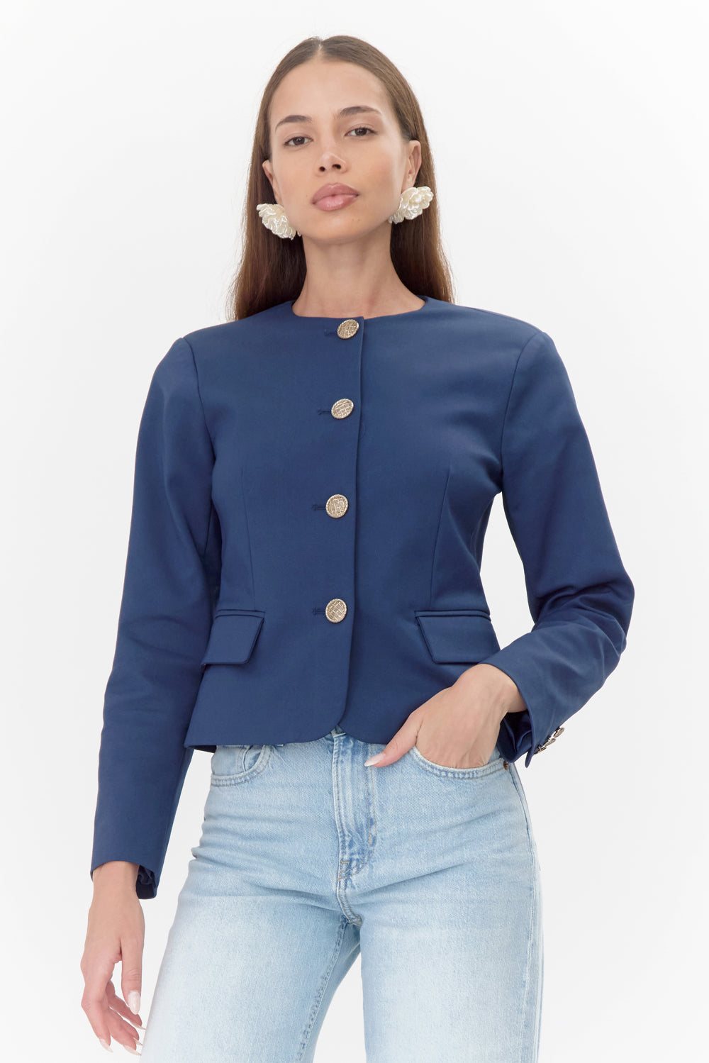 Model wears navy jacket with gold buttons and pocket flaps.