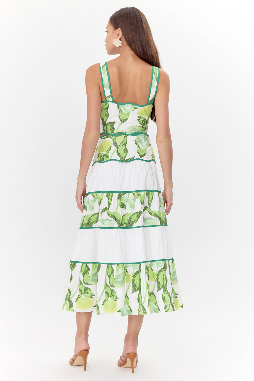 Back view of model wearing tiered, floral midi skirt along with a matching crop top.